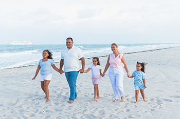 Polyana walking on beach with family